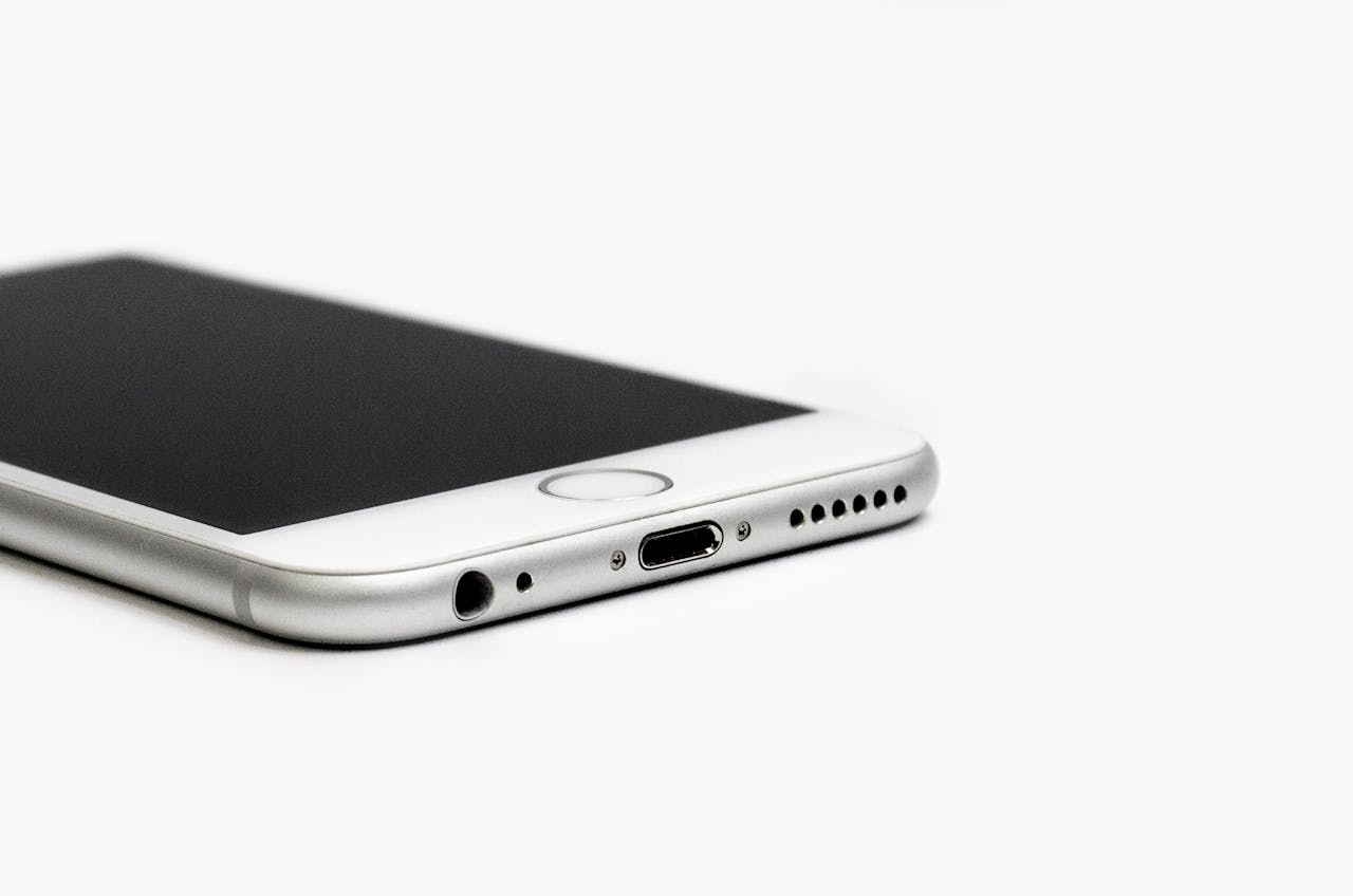 Minimalist image of a sleek smartphone with focus on the bottom edge and ports.